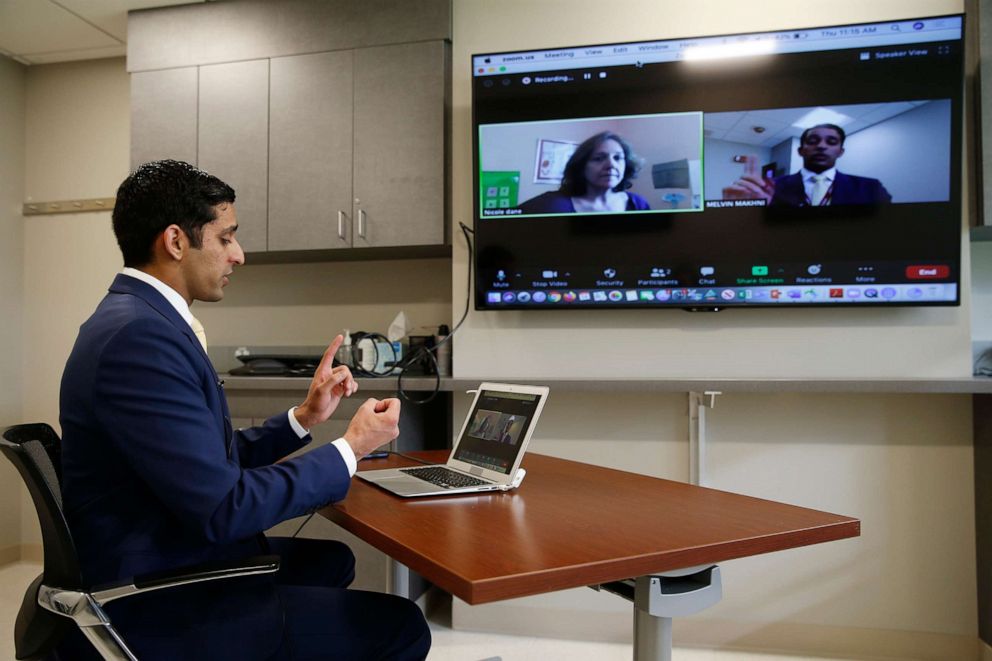 PHOTO: Dr. Melvin Makhni, a spine surgeon in the Department of Orthopedic Surgery at Brigham and Women's Hospital demonstrates a tele-health follow up appointment with Nicole Dane, a patient,  in Boston on May 14, 2020.