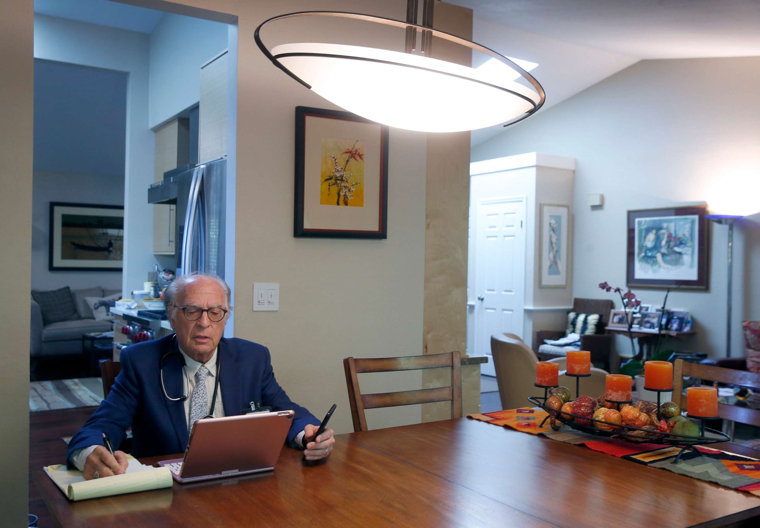PHOTO: Dr. Neil Handelman meets with a patient remotely during a telemedicine appointment to discuss and diagnose possible coronavirus symptoms from his home in San Rafael, Calif. on March 27, 2020.