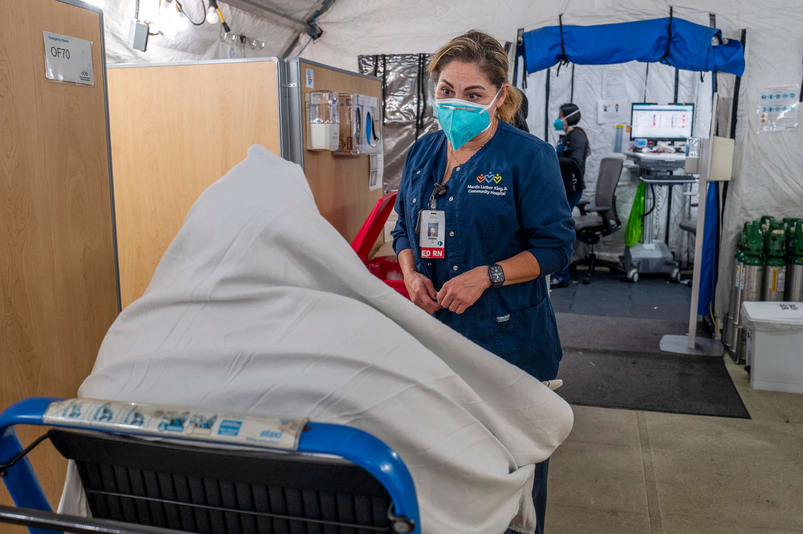 PHOTO: Registered nurse Rafaela Ramirez, right, speaks with a new patient arriving  inside the respiratory tent outside the Emergency Department at Martin Luther King Jr. Community Hospital, Dec. 29, 2021, in Los Angeles.