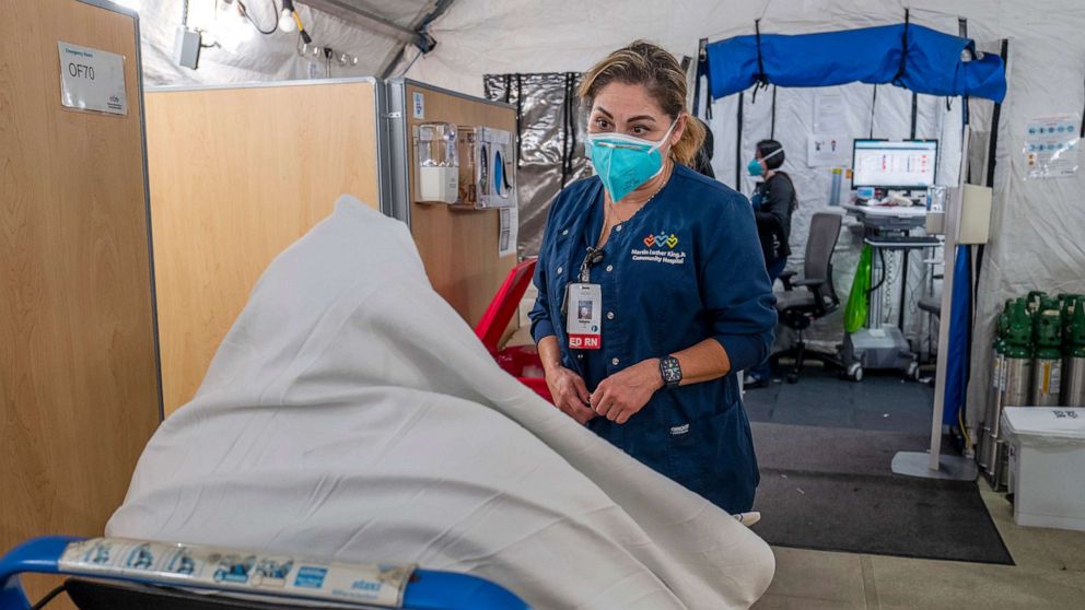 PHOTO: Registered nurse Rafaela Ramirez, right, speaks with a new patient arriving inside the respiratory tent outside the Emergency Department at Martin Luther King Jr. Community Hospital, Dec. 29, 2021, in Los Angeles.