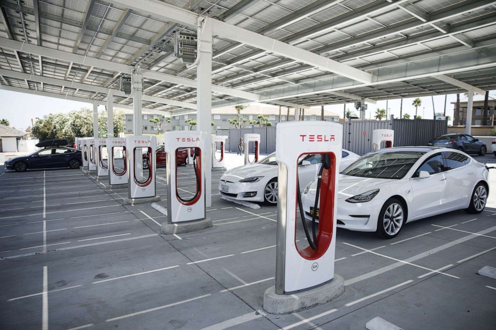 PHOTO: Tesla Inc. Model S and Model 3 electric vehicles charge beneath a solar panel canopy at the Tesla Supercharger station in Kettleman City, Calif., July 31, 2019.