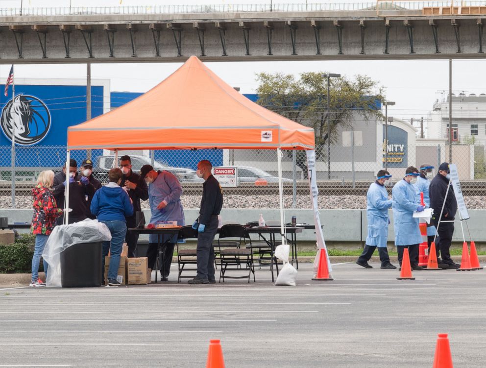 PHOTO: Medical workers work at a drive-through COVID-19 testing site in Dallas, Texas, the United States, March 21, 2020.