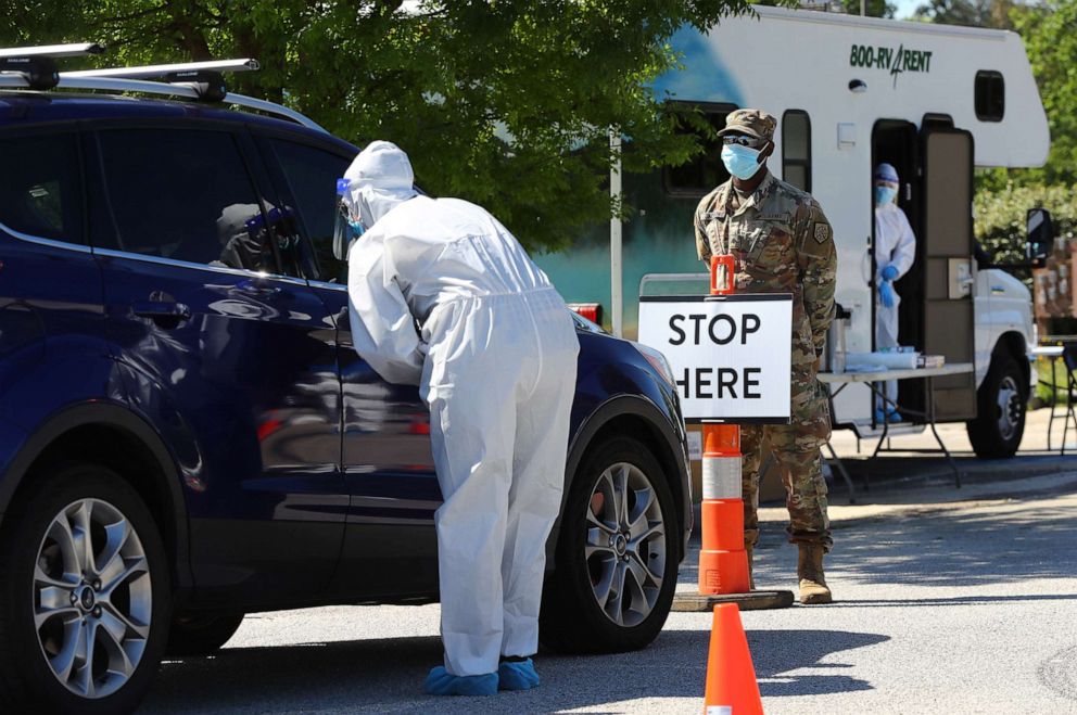 PHOTO: Walmart pharmacist Keri Taylor (left) and Georgia Army National Guard Spc. Korri Jackson help operate a new mobile COVID-19 drive-through testing site at Diamond Lakes Regional Park, April 27, 2020, in Hephzibah near Augusta, Ga.