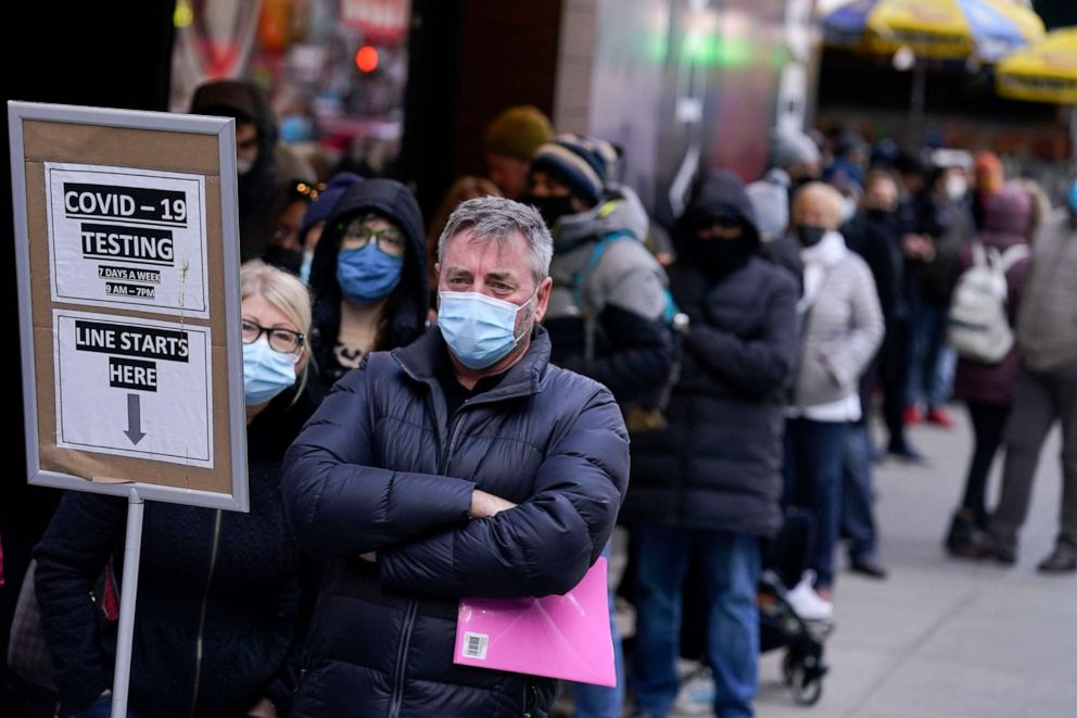 PHOTO: People wait in line at a COVID-19 testing site in Times Square, New York, Dec. 13, 2021.