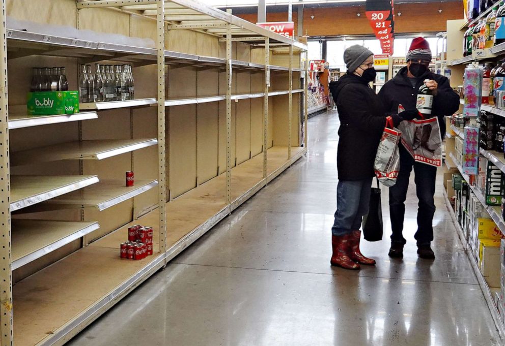 PHOTO: A water bottle shelf is bare as people stock up on necessities at the H-E-B grocery store on Feb. 18, 2021, in Austin, Texas.