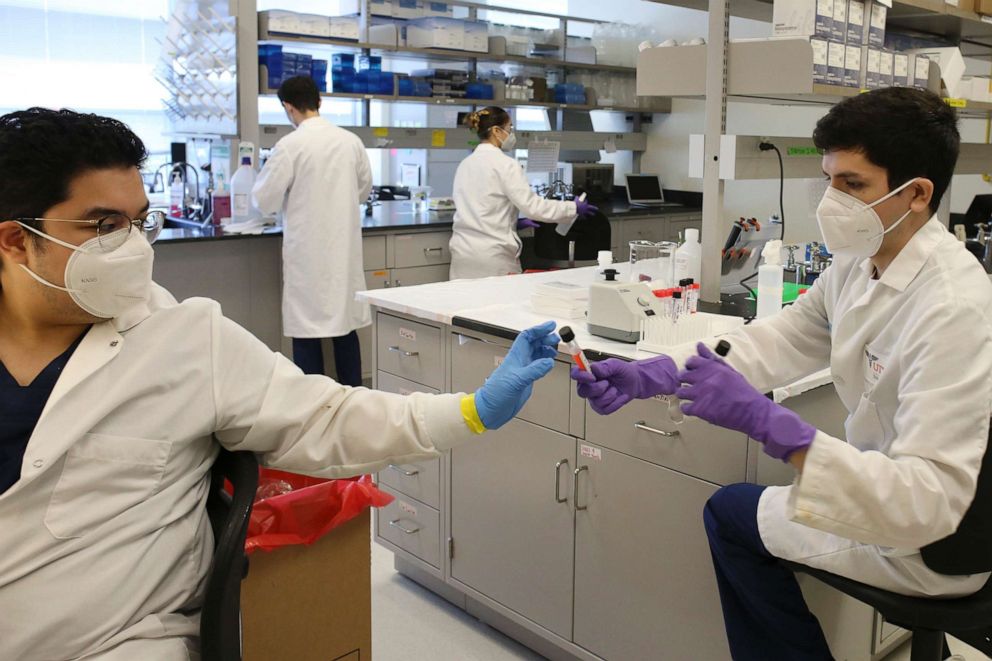 PHOTO: In this Friday, July 10, 2020 file photo, lab technicians work with COVID-19 testing sample at the UT Health RGV Clinical Lab on the UTRGV campus in Edinburg, Texas.
