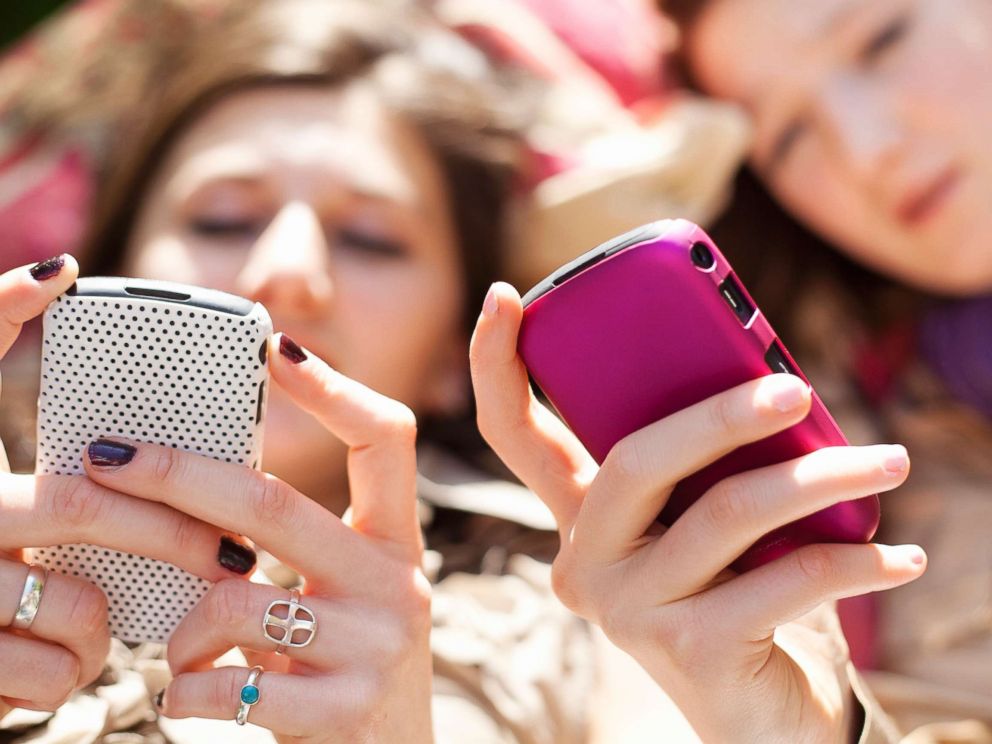 PHOTO: Young women use their phones in this undated stock photo.