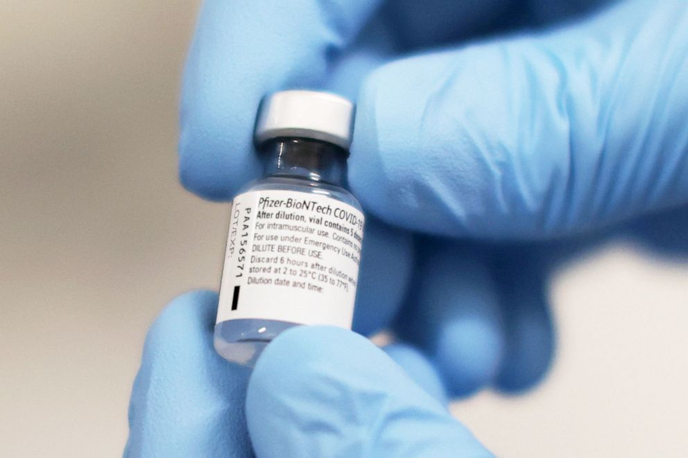 PHOTO: A vial of the Pfizer/BioNTech COVID-19 vaccine is prepared for being administered   in Belfast, Northern Ireland, Dec. 8, 2020.