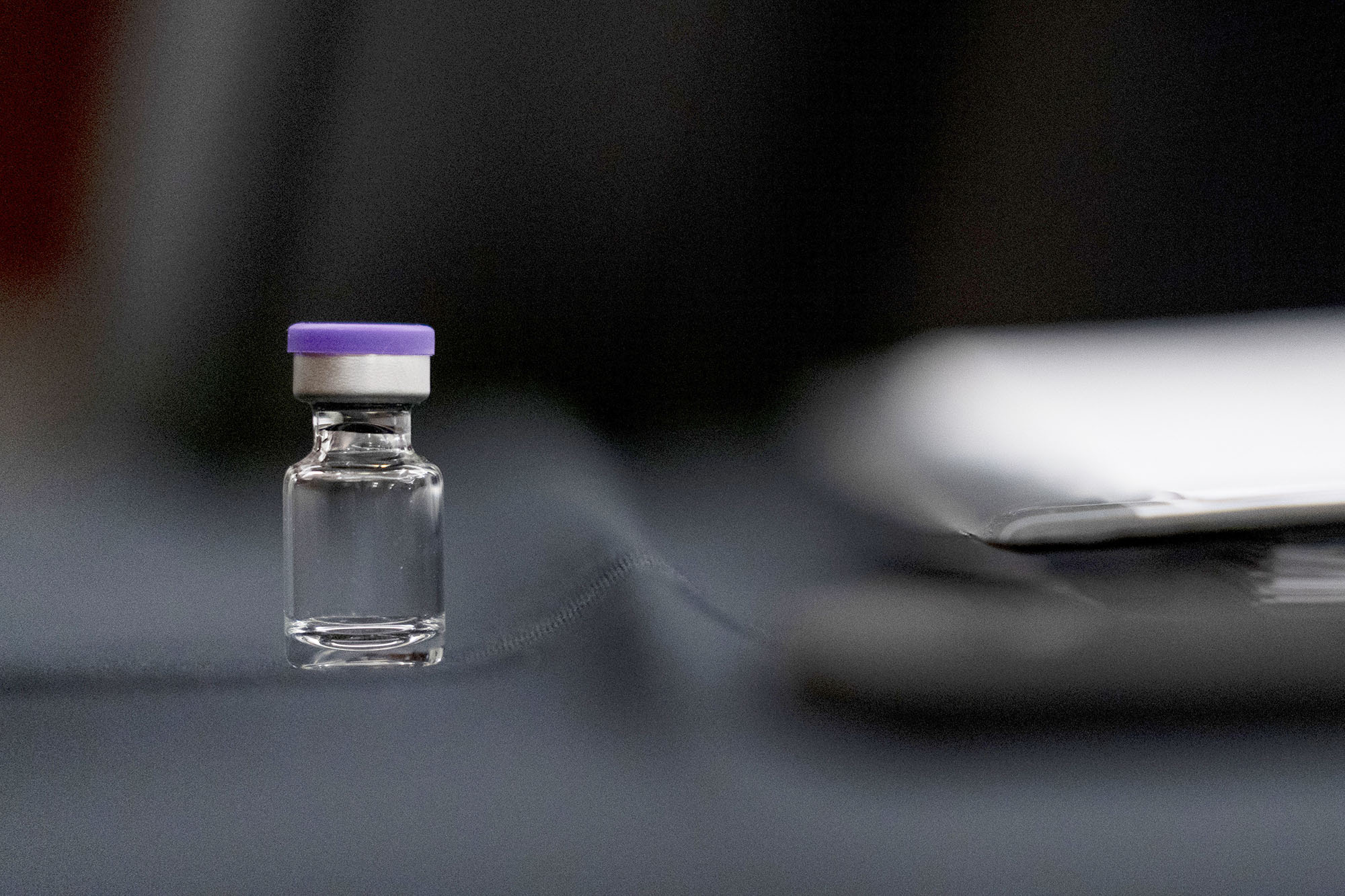 PHOTO: An example of the Pfizer COVID-19 vaccine vial sits on a desk before a Senate Transportation subcommittee hybrid hearing on transporting a coronavirus vaccine on Capitol Hill, Dec. 10, 2020.