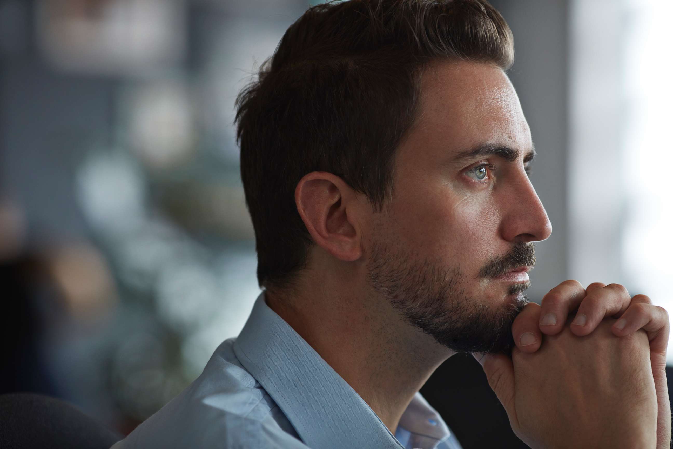 PHOTO: A man looks out the window in an undated stock photo.