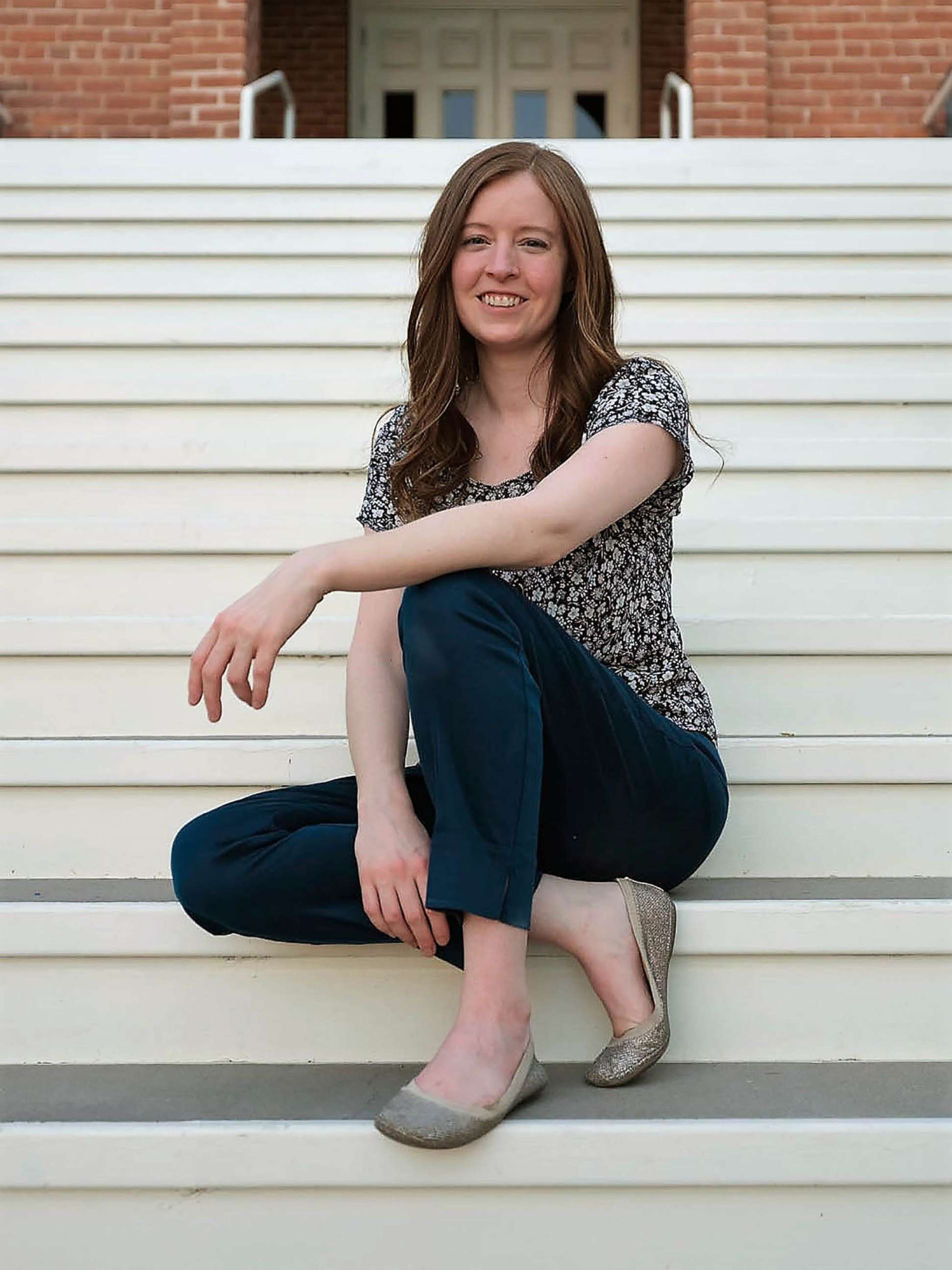 PHOTO: Covid Watch developer Tina White on the steps of Old Main at the University of Arizona in 2020.