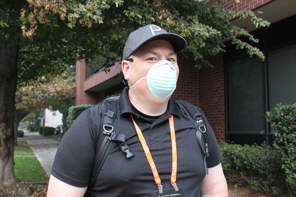 PHOTO: Toby Lewsadder of Los Angeles, who was visiting Sacramento on Nov. 13, 2018, for a conference, wears a dust mask because that is the only one he could find at a local hardware store. Many Sacramento-area stores ran out of the recommended N95 masks.