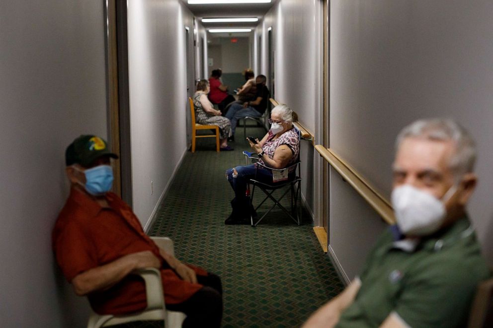 PHOTO: Seniors sit in the hallway after receiving their second dose of the Pfizer COVID-19 vaccine by healthcare workers from Humber River Hospital, inside Caboto Terrace, an independent seniors residence, on April 1, 2021, in Toronto, Canada.