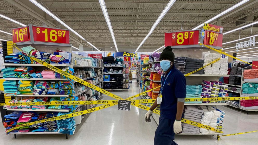 An employee walks past cordoned off aisles of non-essential goods at a Walmart store as new measures are imposed on big box stores due to COVID-19 in Toronto, Canada, April 8, 2021.