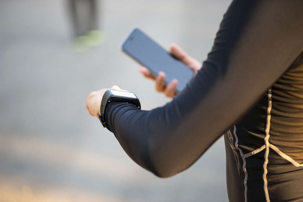 PHOTO: A woman looks at her smart watch.