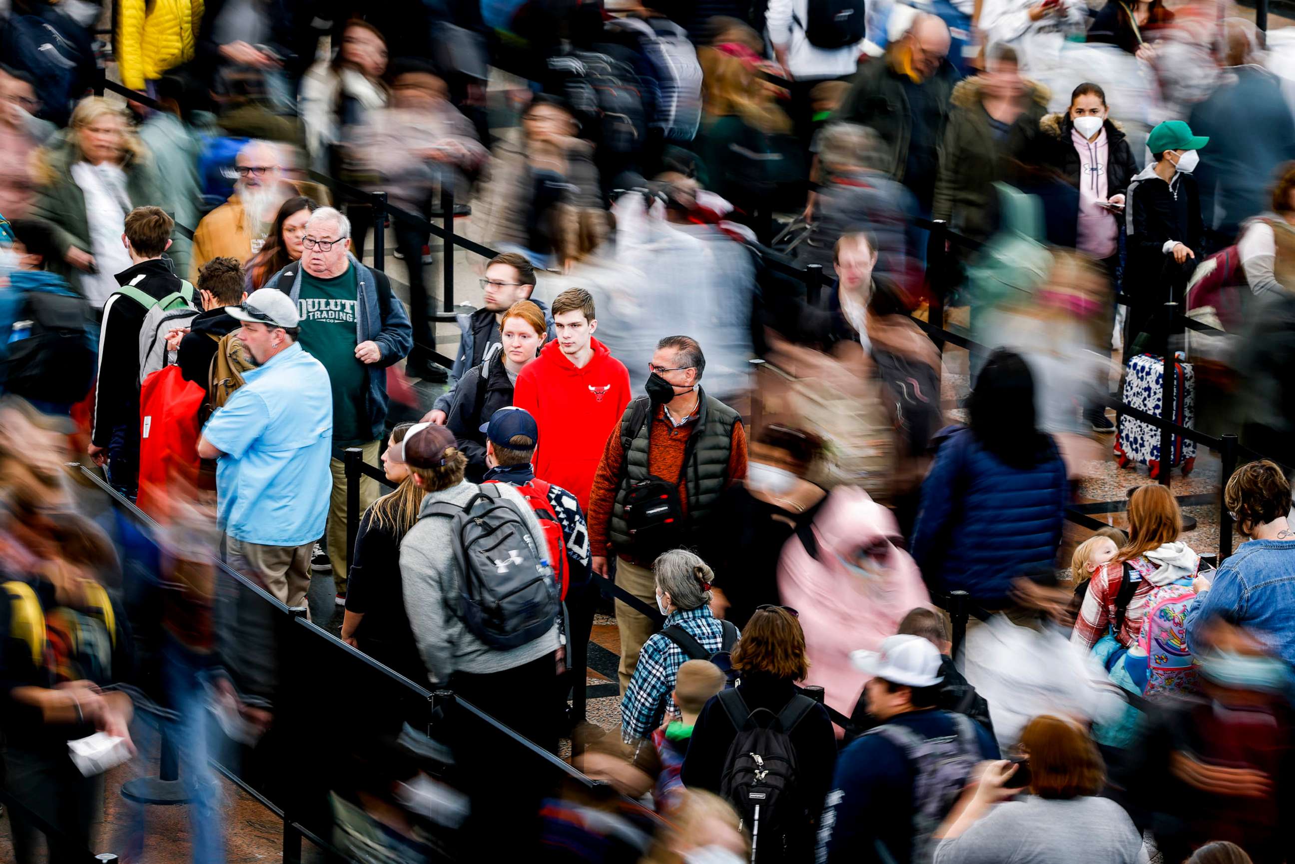 PHOTO: Travelers wait in line before passing through a security checkpoint at Denver International Airport, Dec. 28, 2022 in Denver.