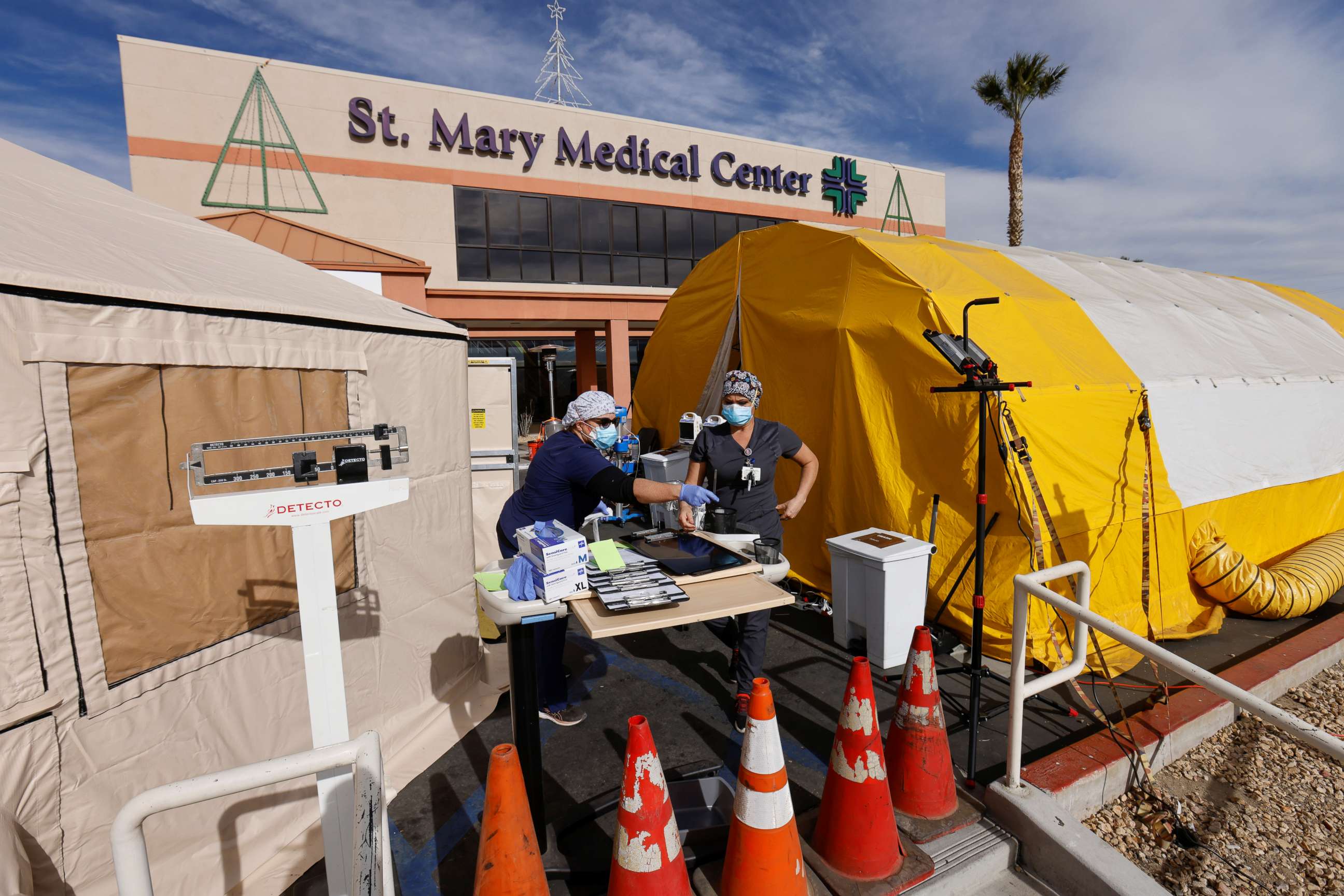 PHOTO: ER tech Brenda de la Cruz, right and nurse Janet Hays, left, work outside St. Mary Medical Center in the triage tents as they handle the overflow at its 200 bed hospital during the outbreak of the coronavirus in Apple Valley, Calif., Dec. 8, 2020.