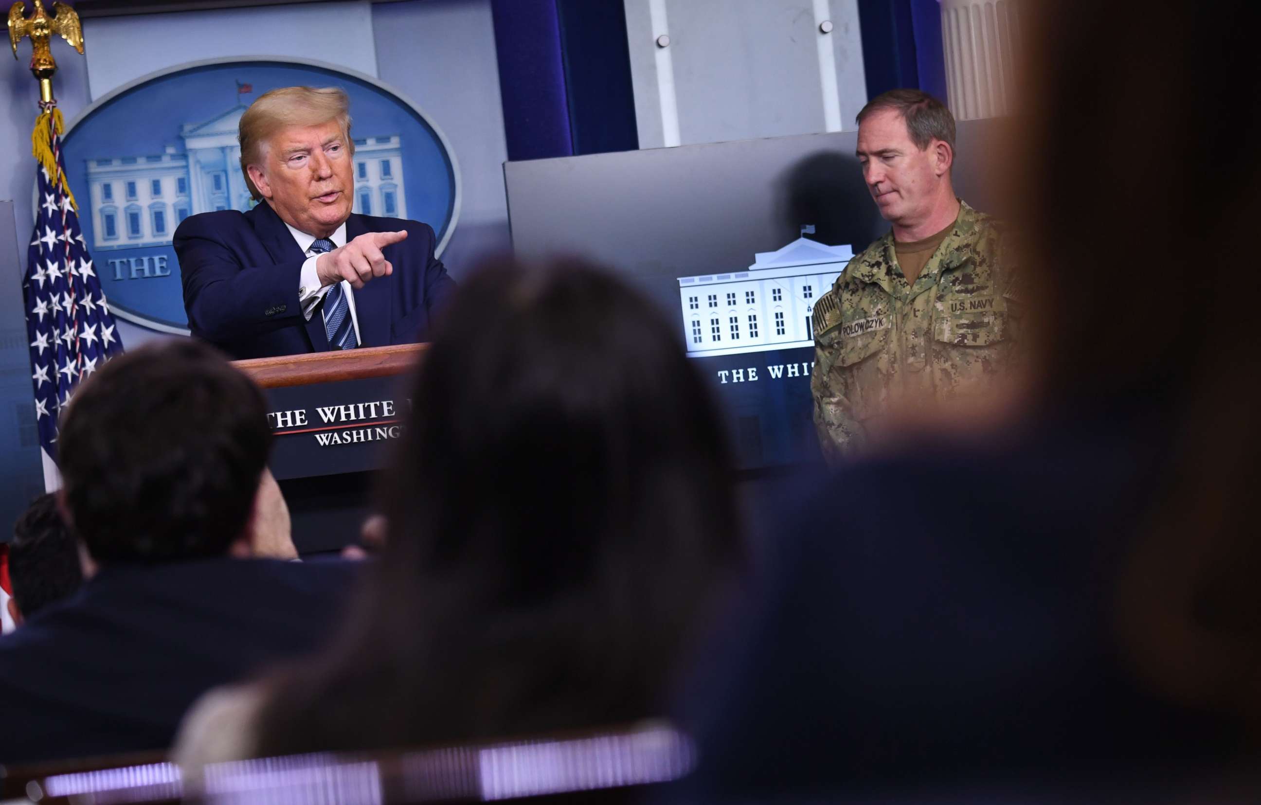 PHOTO: US President Donald Trump speaks as FEMA's supply chain task force lead Navy Rear Adm. John Polowczyk listens during an unscheduled briefing after a Coronavirus Task Force meeting at the White House on April 5, 2020, in Washington, DC. 