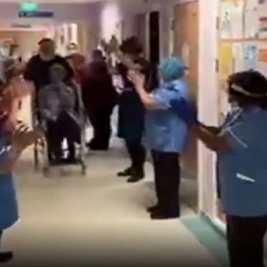 British health workers applaud 90-year-old Margaret Keenan, the first person to be given a COVID-19 vaccine outside of a trial.