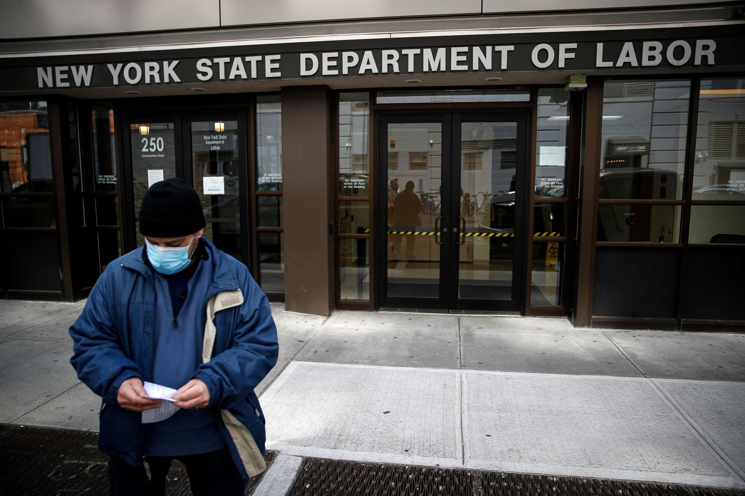 PHOTO: Visitors to the Department of Labor are turned away at the door by personnel due to closures over coronavirus concerns in New York, March 18, 2020. 