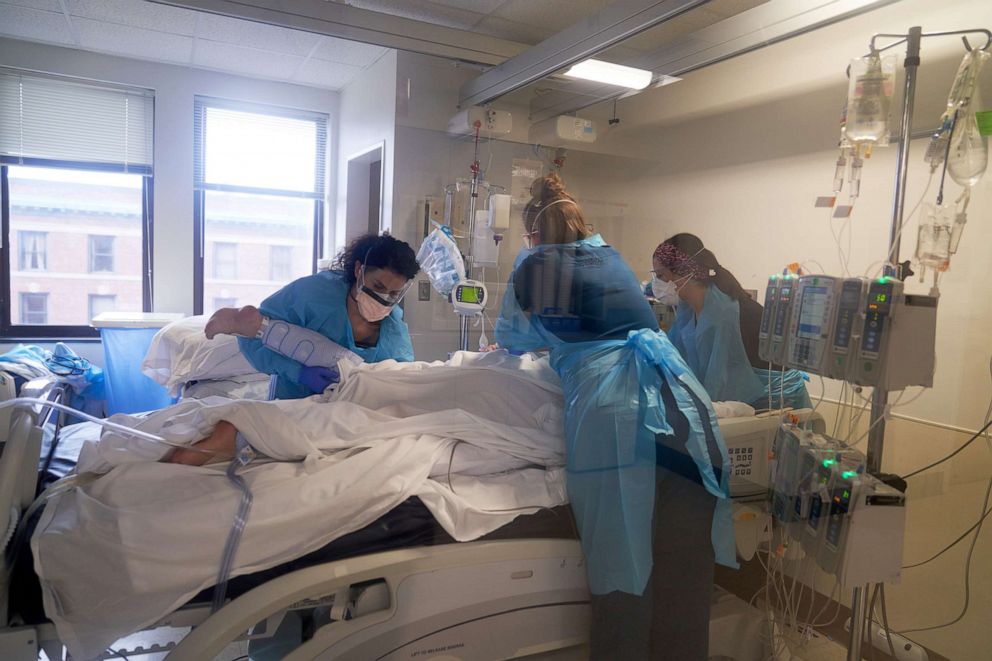 PHOTO: Healthcare workers treat a patient on the Covid-19 ICU floor of the University of Massachusetts Memorial Hospital in Worcester, Mass., Dec. 27, 2021.