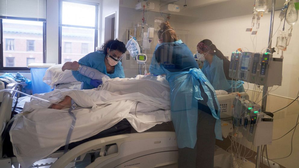 PHOTO: Healthcare workers treat a patient on the Covid-19 ICU floor of the University of Massachusetts Memorial Hospital in Worcester, Mass., Dec. 27, 2021.