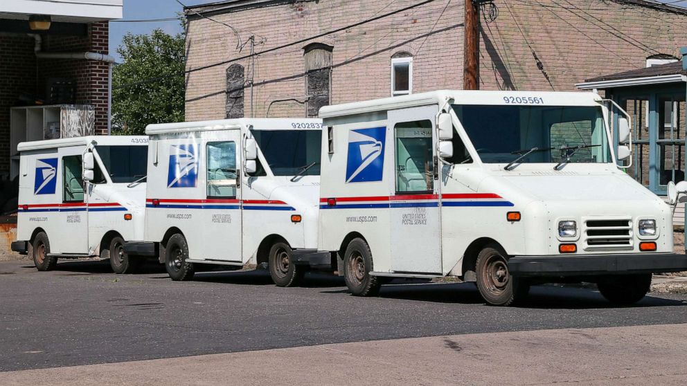 PHOTO: FILE - Three United States Postal Service (USPS) mail trucks are parked in front of the post office in Danville, Penn.