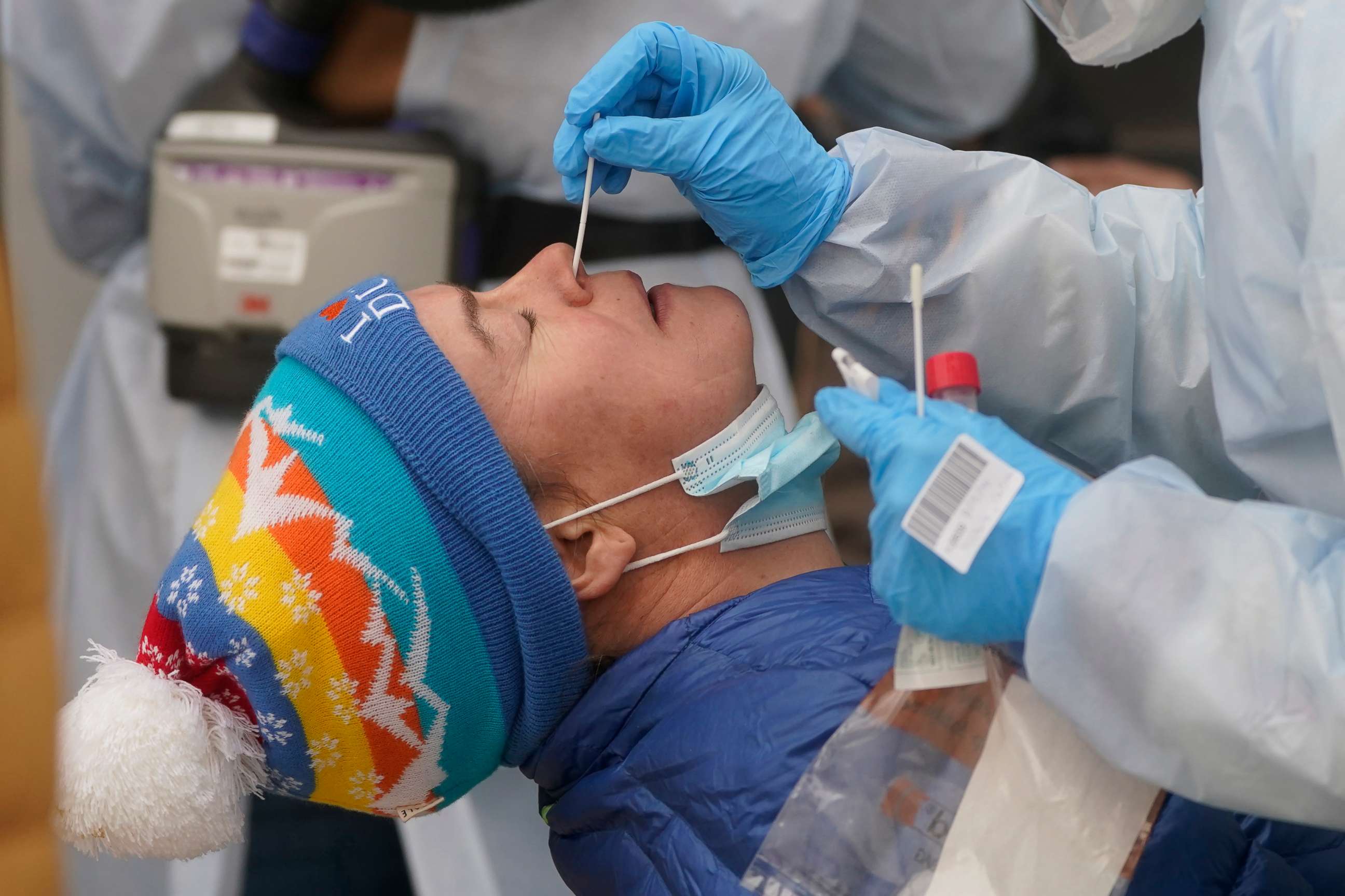 PHOTO: A member of the Salt Lake County Health Department COVID-19 testing staff performs a test on Chrissy Nichols outside the Salt Lake County Health Department, Jan. 4, 2022, in Salt Lake City.