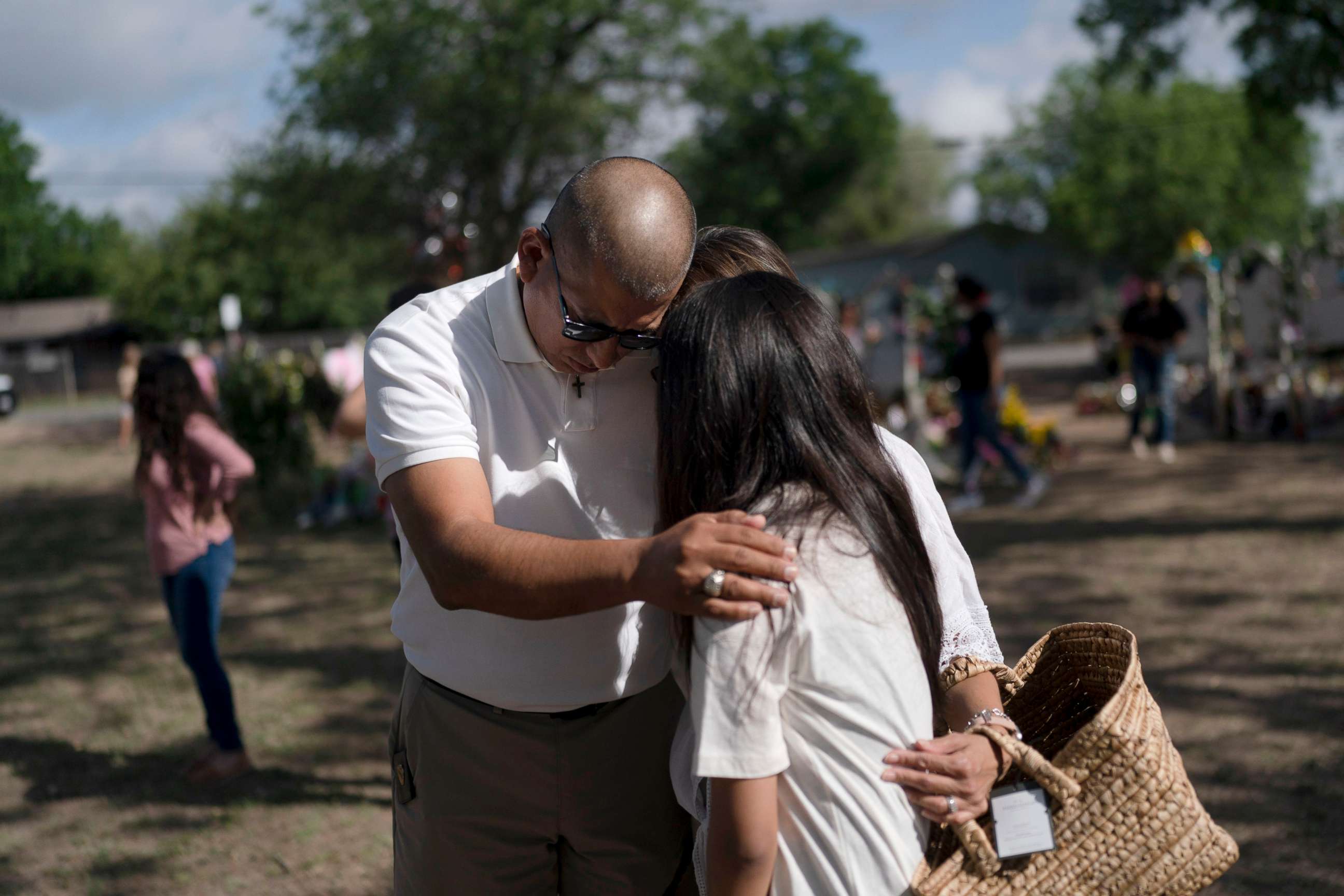 PHOTO: Ernest Oviedo, left, prays with wife, Lori, and their daughter, Vivianna, at a memorial at Robb Elementary School in Uvalde, Texas, June 2, 2022.