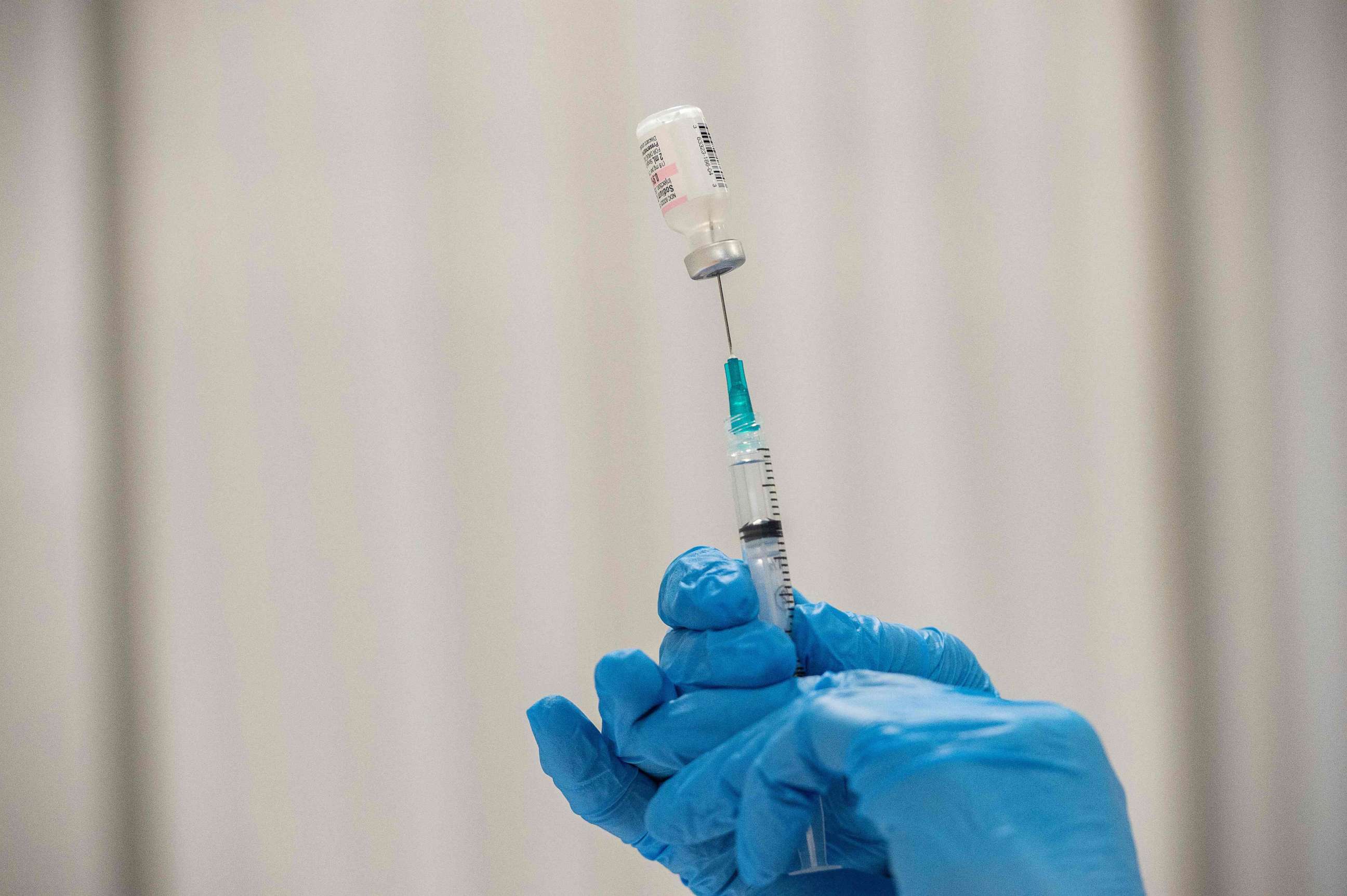 PHOTO: A pharmacist prepares a syringe of Pfizer-BioNTech COVID-19 vaccine in Worcester, Mass., April 22, 2021.