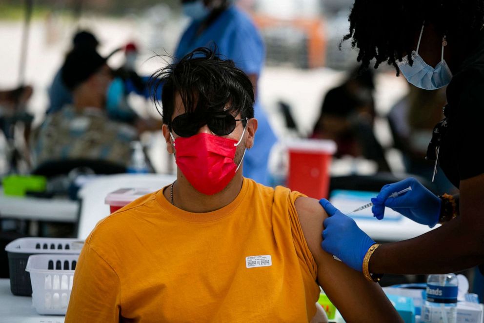 PHOTO: A man receives a shot of Johnson & Johnson COVID-19 vaccine at a pop-up vaccination center at the beach, in South Beach, Fla., May 9, 2021. 