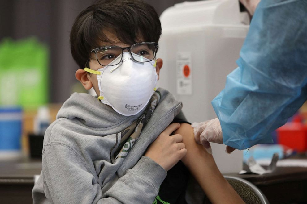 PHOTO: A 14-year-old gets his first vaccine at San Pedro Senior High School, May 24, 2021, in  Los Angeles.