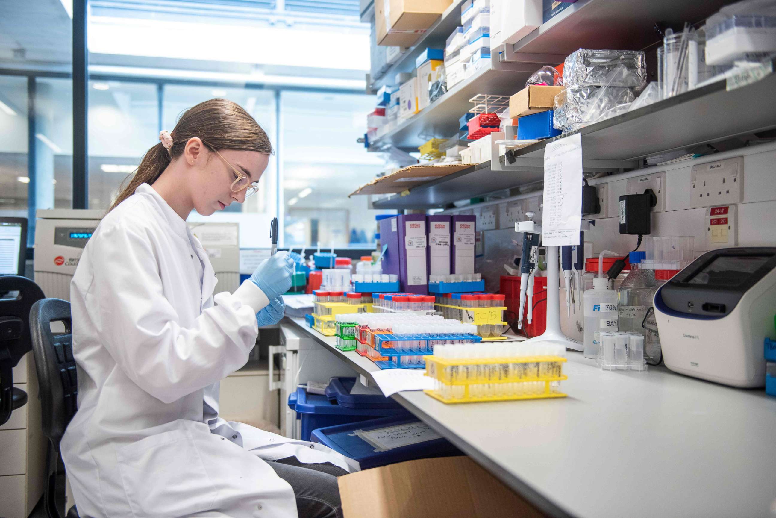 PHOTO: An undated handout picture released by the University of Oxford on November 23, 2020 shows a technician working on the University's COVID-19 candidate vaccine, known as AZD1222, co-invented by the University of Oxford and Vaccitech.