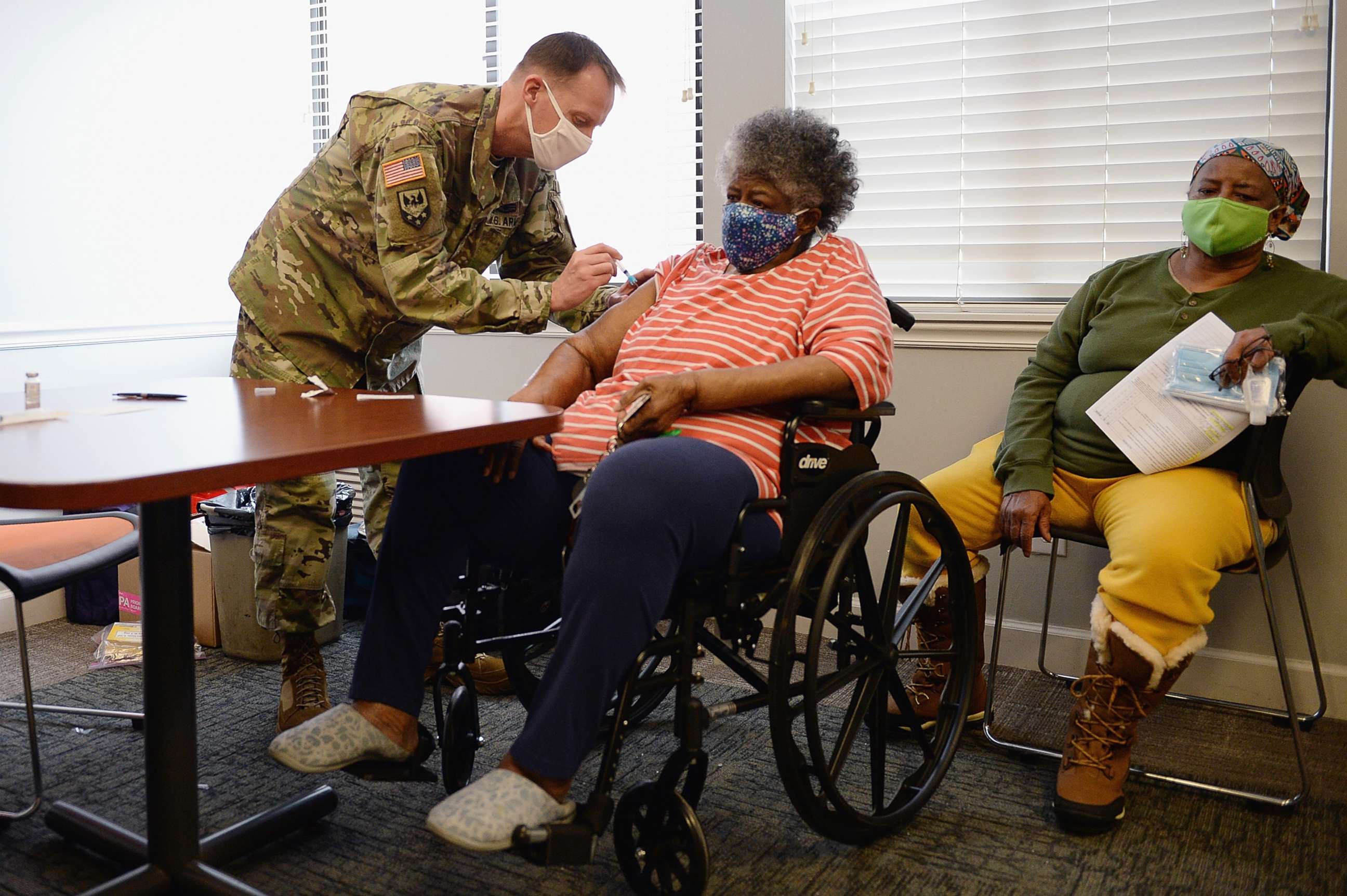 PHOTO: Staff Sergeant Herbert Lins of the Missouri Army National Guard administers the COVID-19 vaccine to a resident during a vaccination event on Feb. 11, 2021 at the Jeff Vander Lou Senior living facility in St Louis, Mo.
