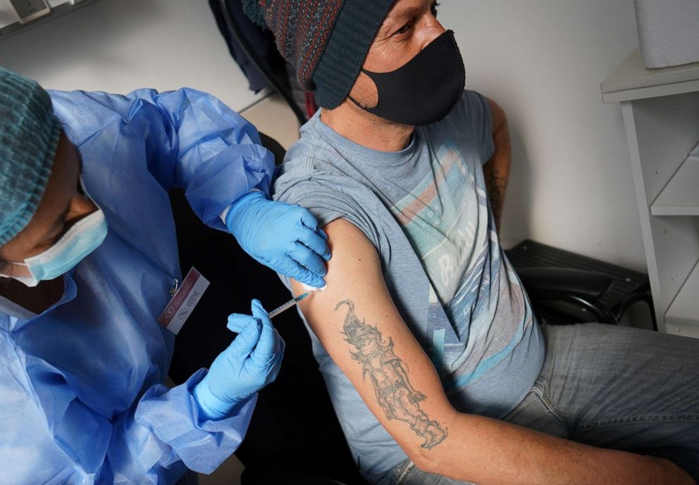 PHOTO: A man who had previously been inoculated against the coronavirus disease (COVID-19) with Sinovac's Coronavac vaccine, gets a third dose of a Pfizer-BioNTech vaccine, in the Hospital de Clinicas, in Montevideo, Uruguay August 16, 2021. 