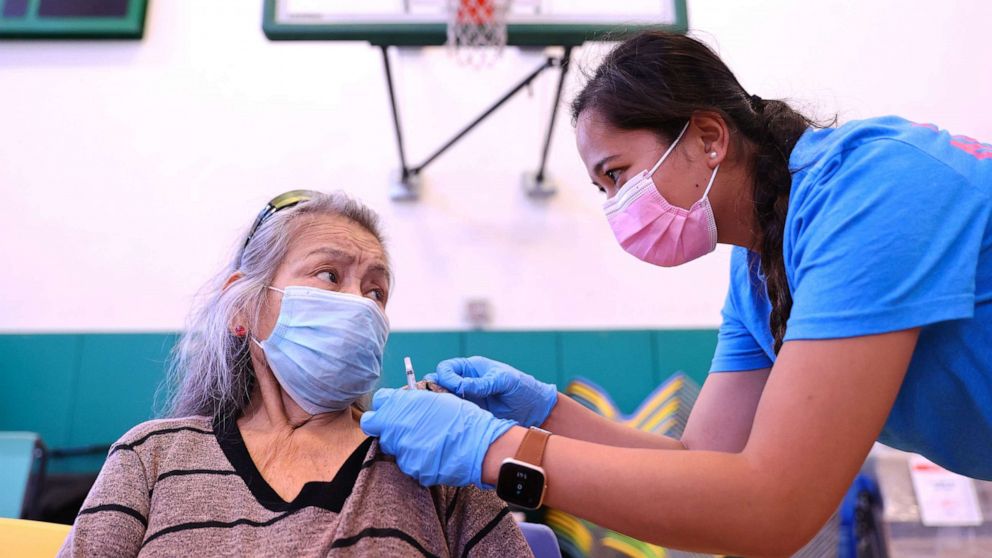 PHOTO: A nurse adjust the shirt of a patient after administering a dose of the Pfizer COVID-19 vaccine at a three-day vaccination clinic at Providence Wilmington Wellness and Activity Center on July 29, 2021, in Wilmington, Calif.