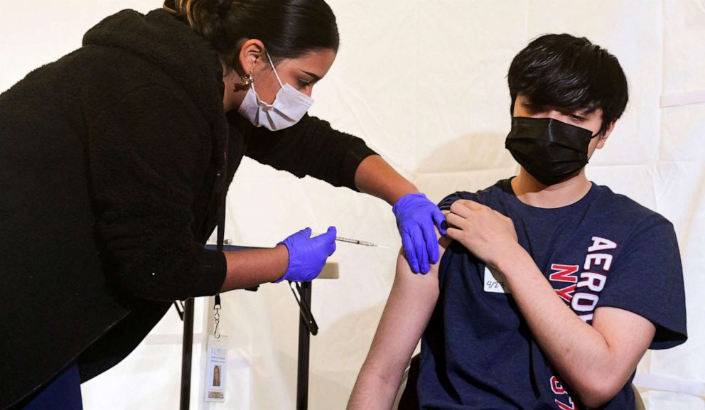 PHOTO: Anthony Briseno, 20, receives his first Pfizer Covid-19 vaccine administered Medical Assistant Karina Cisneros from St. John's Well Child and Family Center at Abraham Lincoln High School in Los Angeles, April 23, 2021.