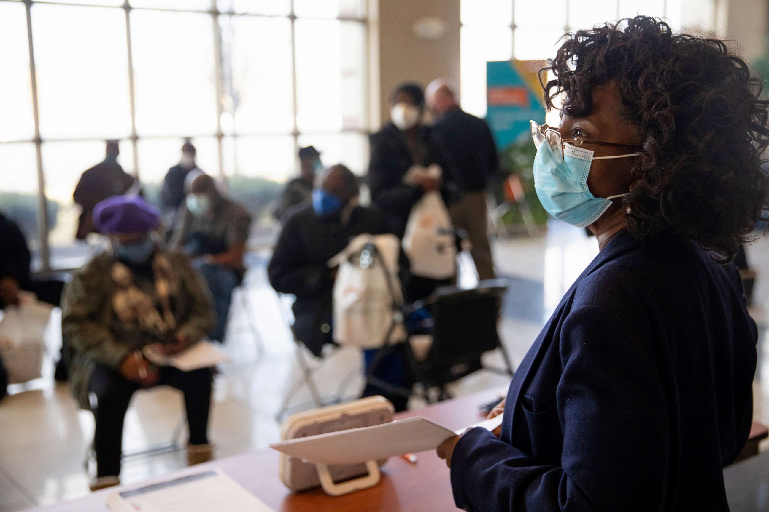PHOTO: A nurse looks over the observation area as seniors wait after receiving their coronavirus disease (COVID-19) vaccinations at Second Ebenezer Church in Detroit, Feb. 27, 2021.