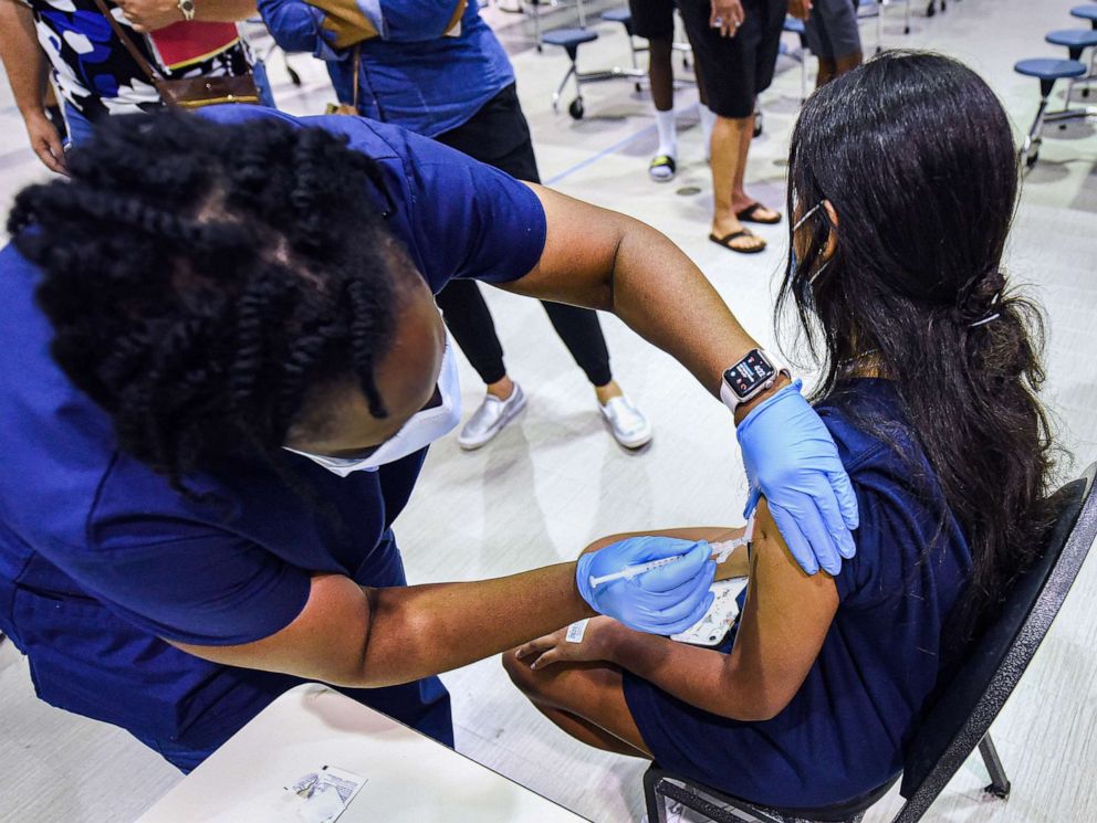 PHOTO: A nurse gives a girl a dose of the Pfizer vaccine at a COVID-19 vaccine clinic at Lyman High School in Longwood, Fla., Sept. 8, 2021.
