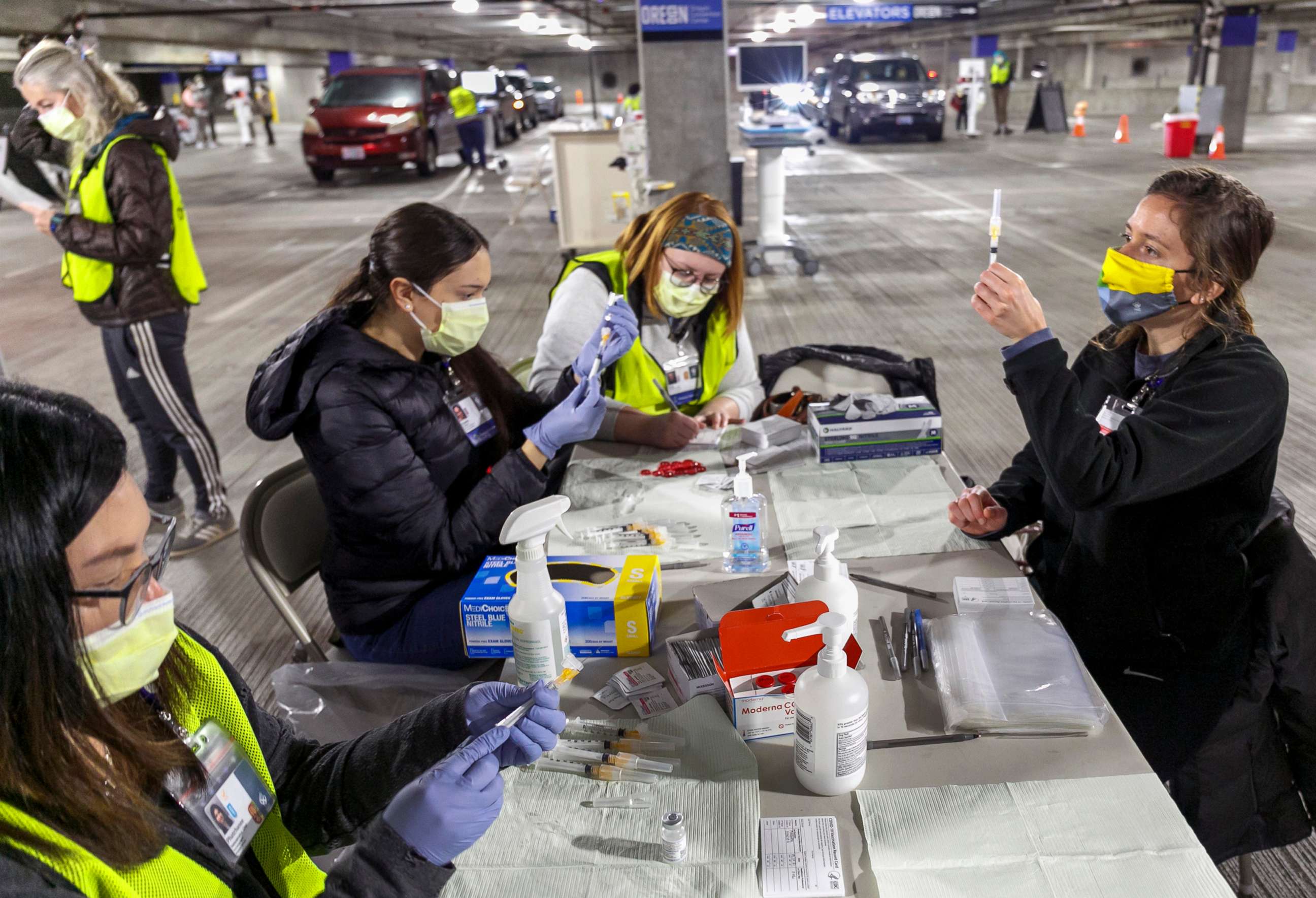 PHOTO: Medical professionals from Oregon Health & Science University load syringes with the Moderna COVID-19 vaccine at a drive-thru vaccination clinic in Portland, Ore., Jan. 10, 2021.