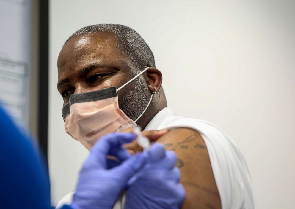 PHOTO: Patient Specialist Jeffrey Tolbert receives the Pfizer-BioNTech COVID-19 vaccine through Salem Health on Thursday, Dec. 17, 2020, at Salem Hospital in Salem, Ore.