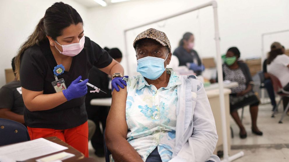 PHOTO: Anna Mendez, LPN, administers a Moderna COVID-19 vaccine to Vern Henderson at a clinic set up by Healthcare Network on May 20, 2021 in Immokalee, Florida.