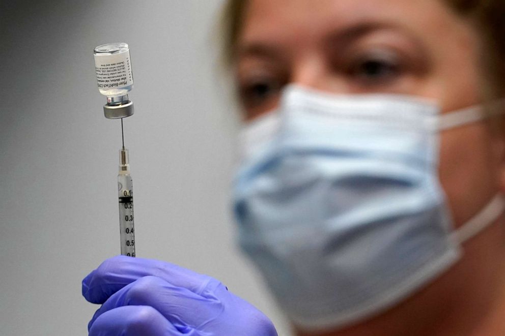 PHOTO: Hollie Maloney, a pharmacy technician, loads a syringe with Pfizer's COVID-19 vaccine at the Portland Expo in Portland, Maine, March 2, 2021.