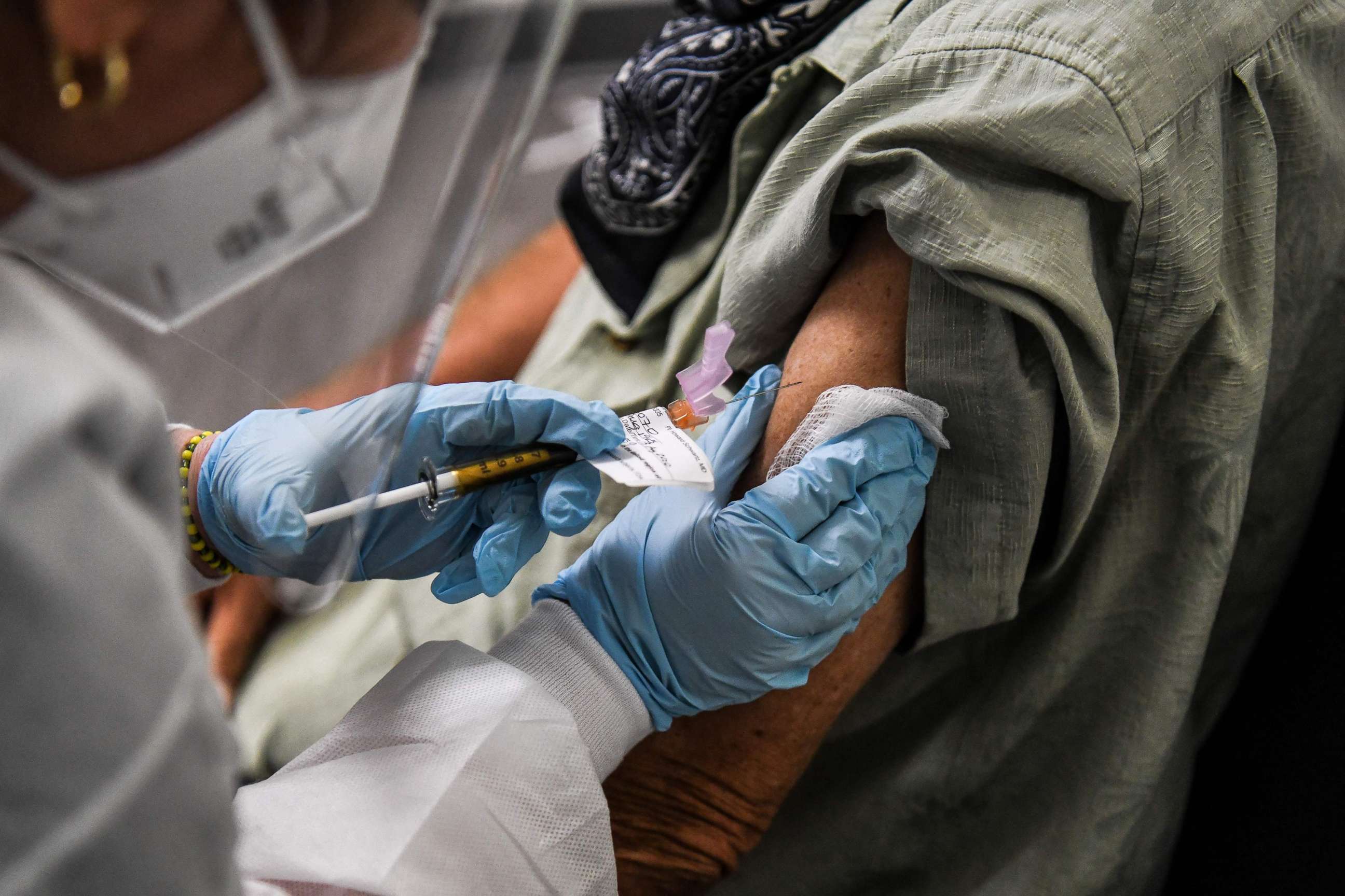 PHOTO: A man receives a COVID-19 vaccination from Yaquelin De La Cruz at the Research Centers of America (RCA) in Hollywood, Fla., Aug. 13, 2020. 