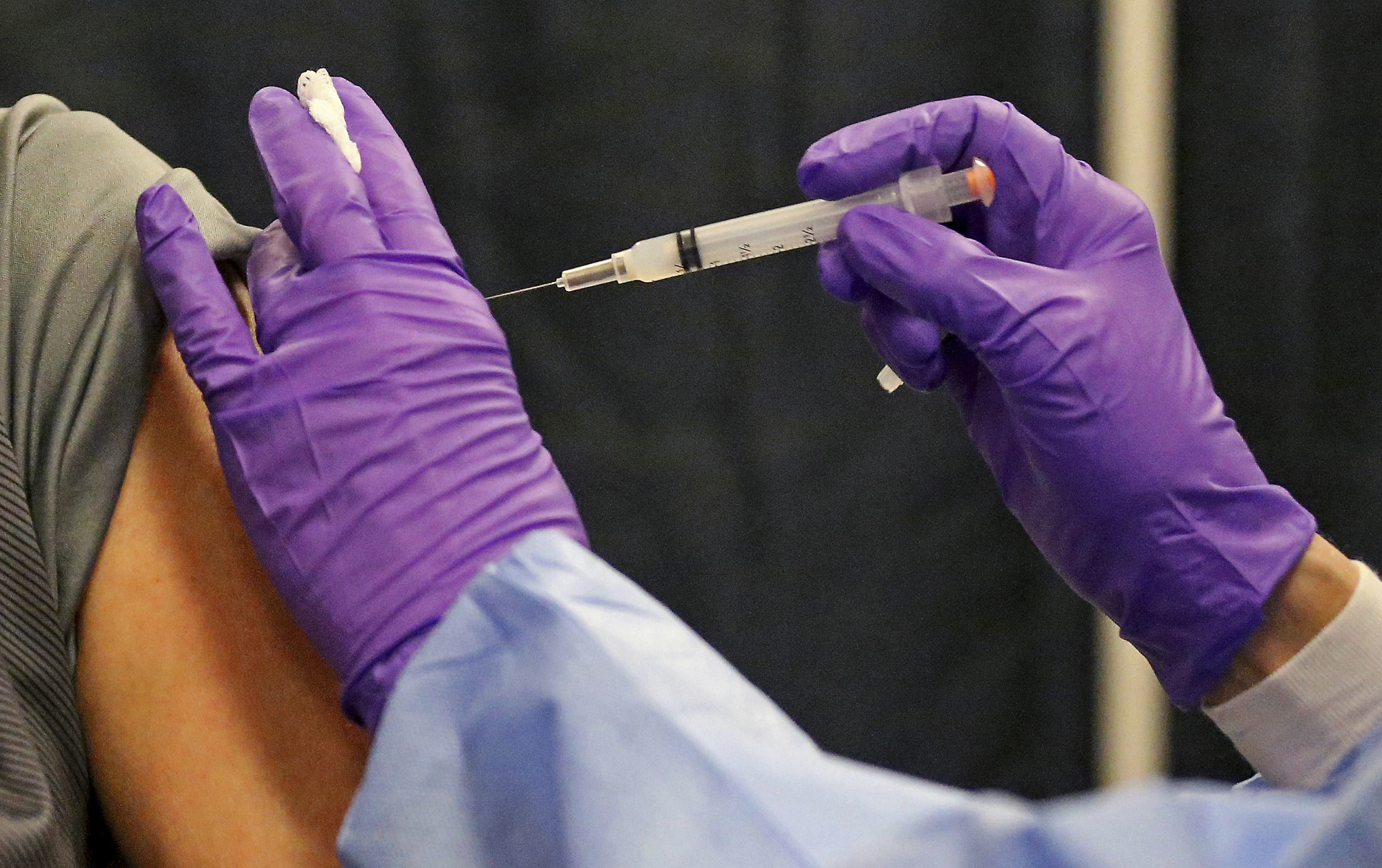 PHOTO: FILE - A man gets a COVID-19 vaccine at a mass vaccination site at the Natick Mall on Wednesday, Feb. 24, 2021, in Natick, Mass. 