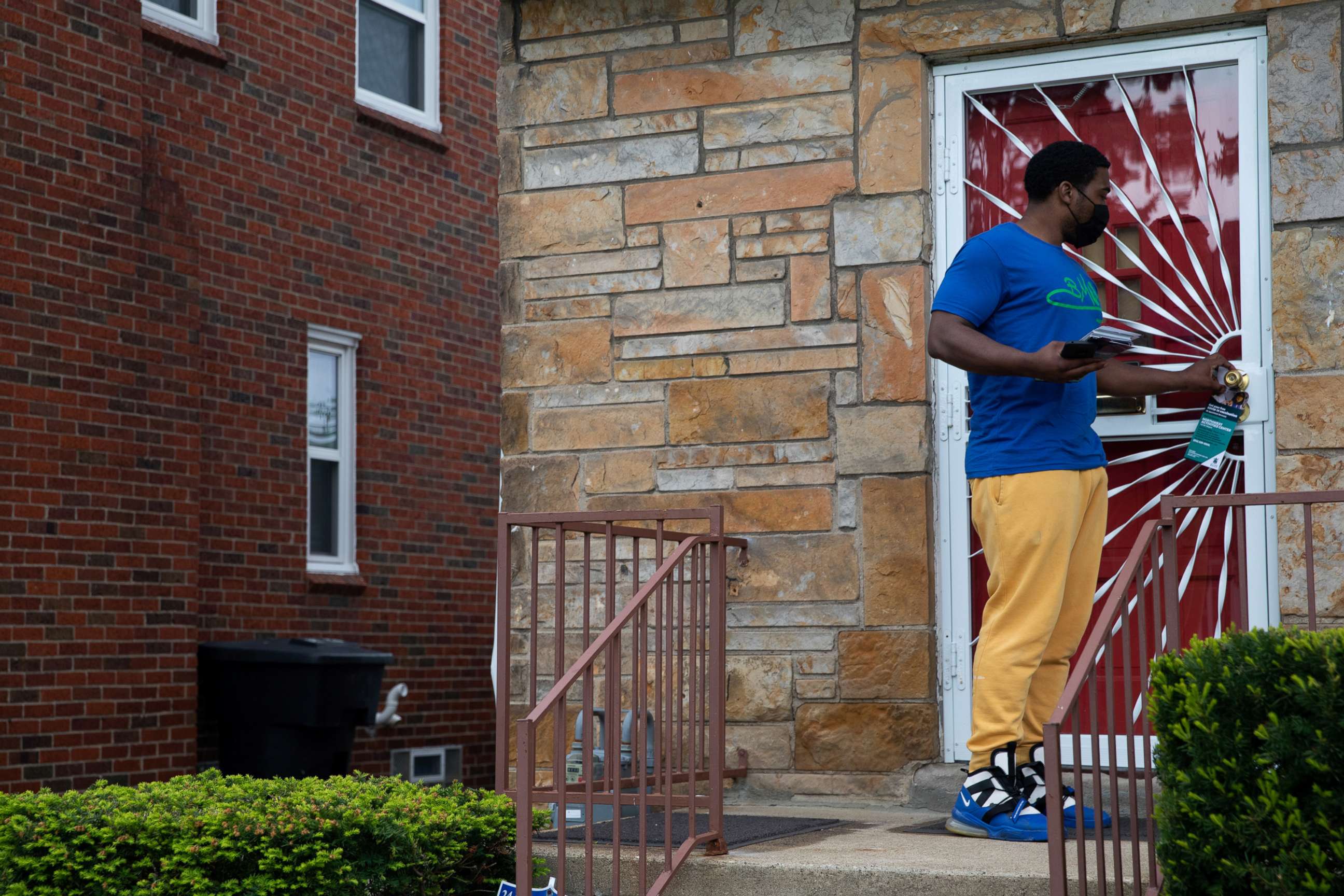 PHOTO: Robert Day from Better Men Outreach knocks on doors during a door-knock campaign to provide information about where people can get their vaccinations and answer questions related to hesitancy around the COVID-19 vaccine in Detroit, May 4, 2021.