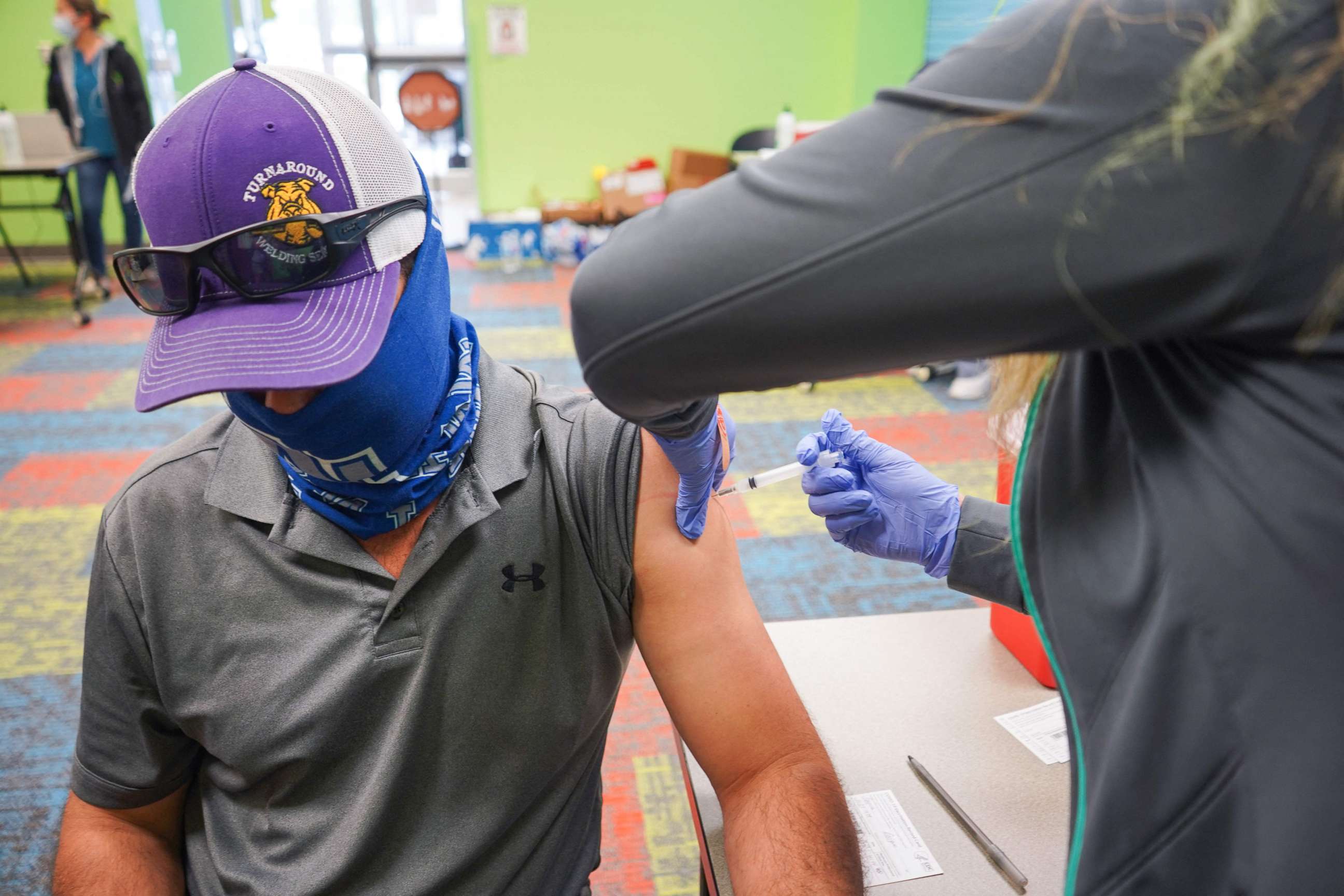 PHOTO: A health care worker vaccinates a man with the COVID-19 vaccine on April 30, 2021, as the Pasadena, Texas, Public Library hosts a mobile vaccine clinic set up by Harris County Public Health.