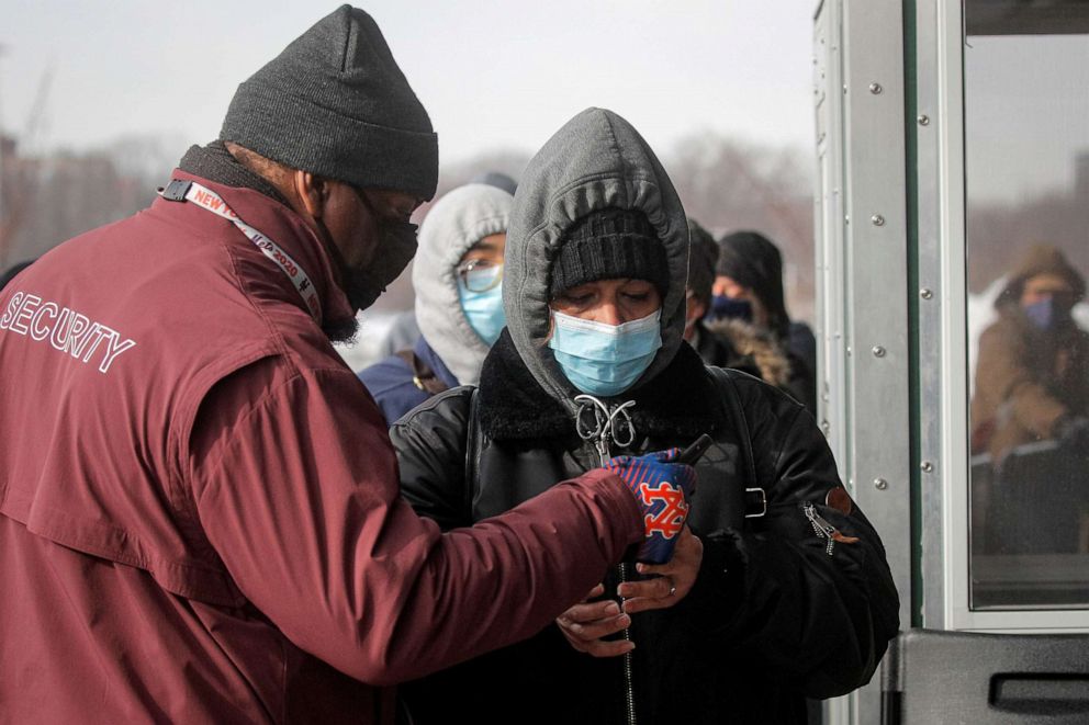 PHOTO: A person is checked for an appointment by security before receiving the coronavirus disease (COVID-19) vaccine outside Citi Field in Queens, New York, Feb. 10, 2021.