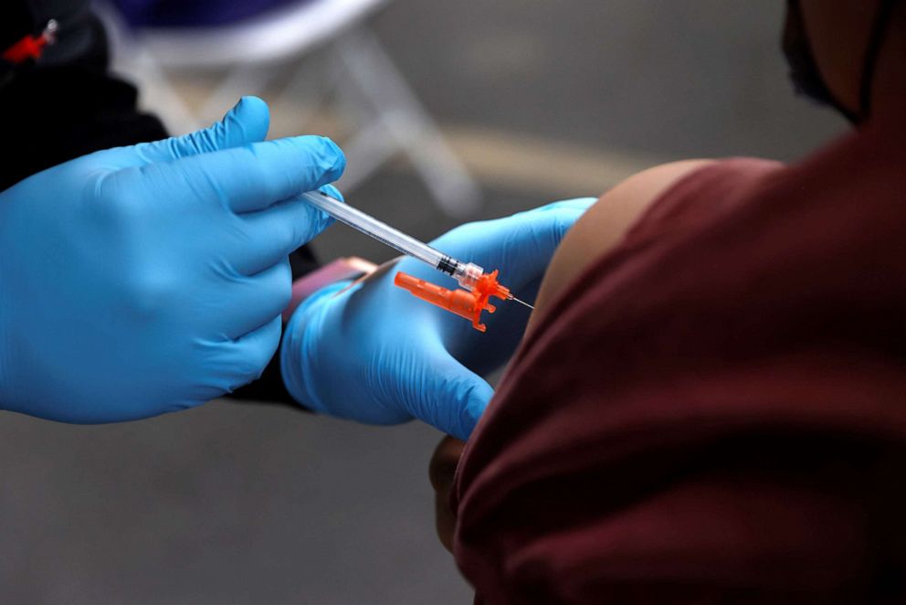 PHOTO: In this Jan. 29, 2022, file photo, a health care worker gives a COVID-19 vaccine to a person at a vaccination site in Los Angeles.