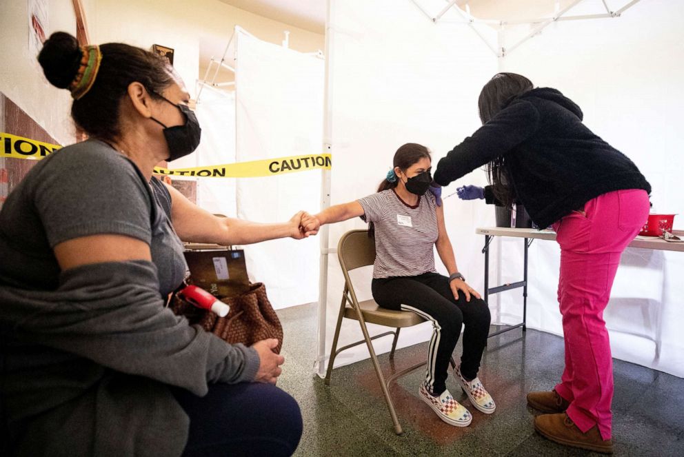 PHOTO: A 21-year-old receives a shot of COVID-19 vaccine during a vaccination drive organized by St. John's Well Child and Family at the Abraham Lincoln High School in Los Angeles, April 23, 2021.